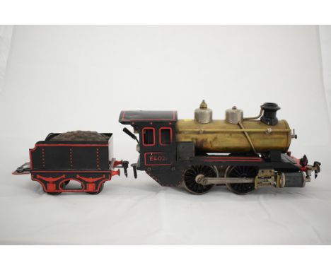 Marklin (Maerklin) 1-gauge 0-4-0 live steam locomotive, R4021 exposed brass and black painted livery, with tender.