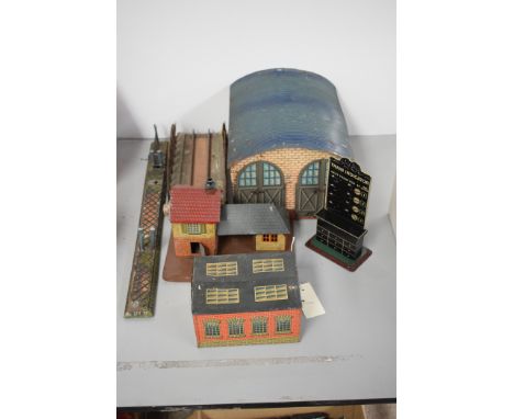 Bing tinplate items, to include: an 0-gauge engine shed; a double engine shed; a small building; a train indicator timetable 