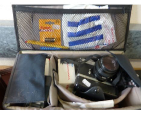 A CAMERA BAG, with a Minolta XD-5 SLR camera fitted with a 50mm 1:1.7 lens and motor winder, an Auto 132X flash and two insta