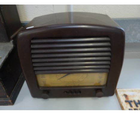 A G.E.C. THREE BAND BROWN BAKELITE RADIO, Cat No.B.C.4655, louvered front over single blade type programme dial, four push bu