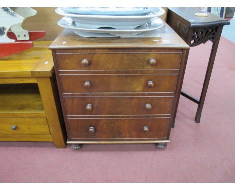 A XIX Century Mahogany Commode, with a hinged lid, on turned legs.