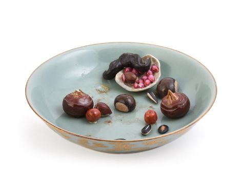 An unusual Chinese Tromp L'oeil dish, the interior with fruit, the exterior wit celadon glaze and gilded with bats and clouds