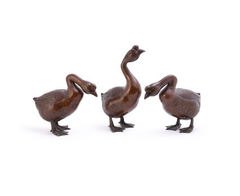 Three amusing Japanese bronzed spelter models of Geese, with light brown graduated patina, one 30cm high and two 20cm high (3