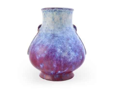 A Chinese flambé glazed vase, the baluster body with moulded handles, applied overall with a brilliant plum-coloured glaze ac