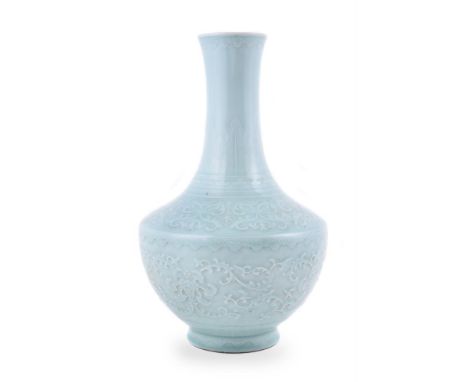 A Chinese carved celadon-glazed bottle vase, perhaps 19th century or Republic, with a globular body sweeping up to a slender 