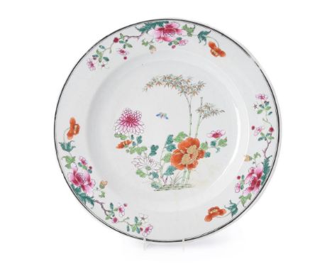 A Chinese Famille Rose dish, Qianlong, painted with bamboo and flowers in colours with iron-red and gilt details, 38.5cm diam