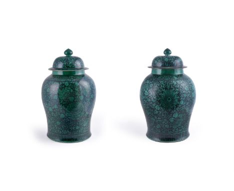 An attractive large pair of Chinese Famille Noire 'Temple' vases and covers, Qing Dynasty, 19th century, enamelled in green w