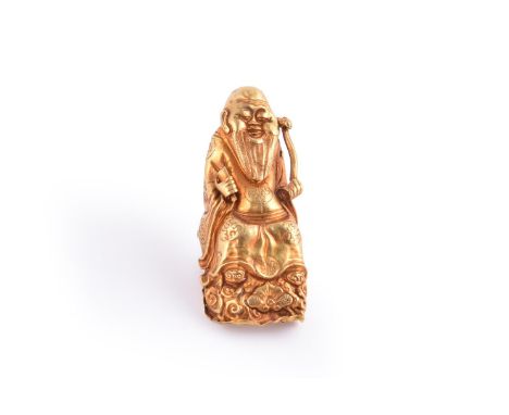 A Chinese gold 'Immortal' nail guard, late Qing Dynasty, depicting a sage holding a ruyi sceptre and scroll, marked zu chi wh