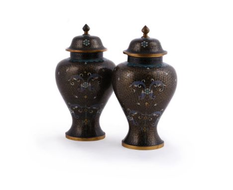 A pair of Chinese cloisonne baluster vases and covers, 20th century, with floral decoration on a dense black scroll ground, 2