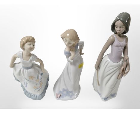 Three Nao figures of girls, tallest 27cm.