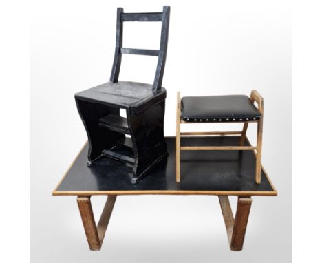 An ebonised metamorphic library step chair, a black vinyl upholstered stool and similar rectangular coffee table 