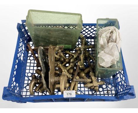 A crate of vintage brass door handles various 
