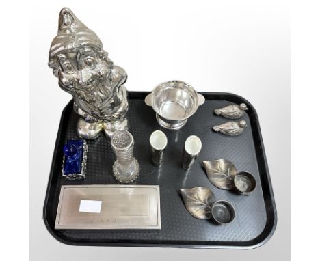 A group of silver-plated wares, a silver-finished gnome, cigarette box, pair of duck salts and peppers, Tag candle holders, W