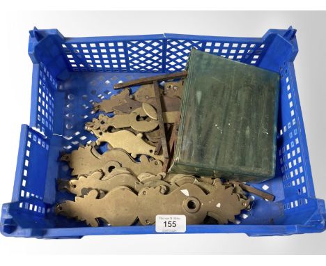 A crate of vintage brass door plates