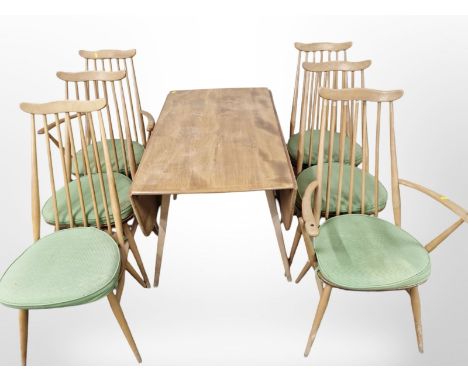 An Ercol elm and beech drop leaf dining table, width 110 cm and six spindle back dining chairs 