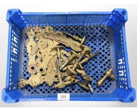 A crate of vintage brass door handles and plates 