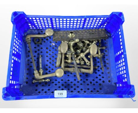 A crate of vintage brass door handles and fixings 