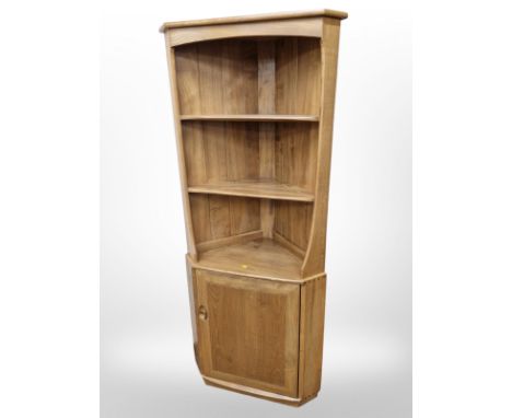 An Ercol elm corner cabinet, height 179 cm 