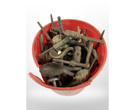 A tub of vintage brass door handles 