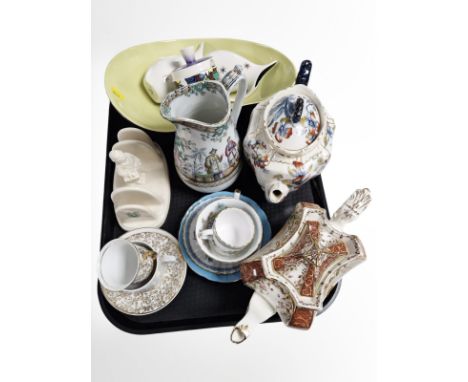 A group of ceramics including Victorian transfer-printed teapots, Ringtons toast rack, teacups and coffee cans including Spod