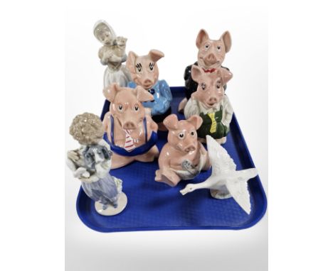 Five Wade Natwest pigs, a Lladró figure of a child holding a dog, a swan, and a Nao figure of a girl holding a lamb. CONDITIO