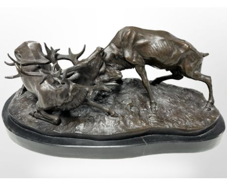 After Pierre-Jules Mêne, a bronze group of two stags locking antlers on black marble plinth, 44cm wide.