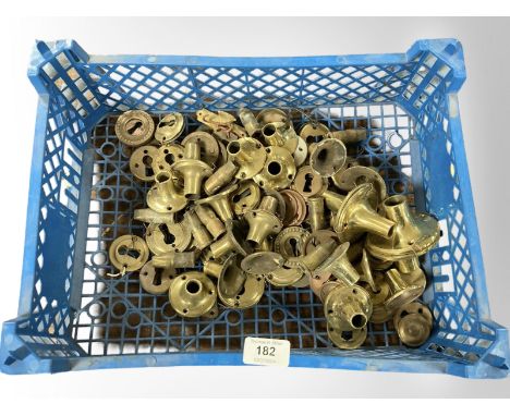 A crate of vintage brass door handle collars 