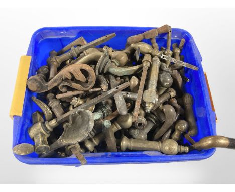 A tub of vintage brass door handles 