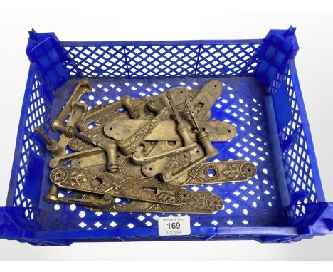 A crate of vintage brass door handles and lock plates 