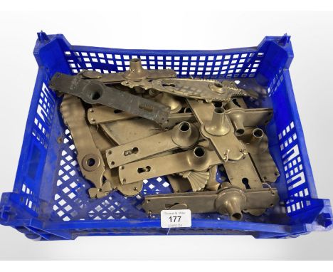 A crate of vintage brass door handle plates 