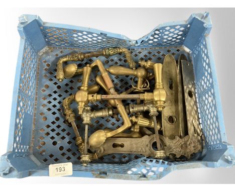 A crate of vintage brass door handles and plates 