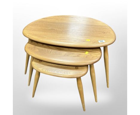 An Ercol nest of three elm and beech "pebble" tables, width 65 cm 