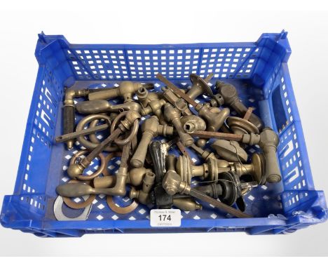 A crate of vintage brass door handles and parts 