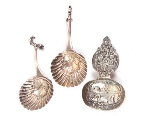 Three 19th Century Dutch silver caddy spoons, comprising a pair with leaf and shell bowls to curving handles, each with a fig