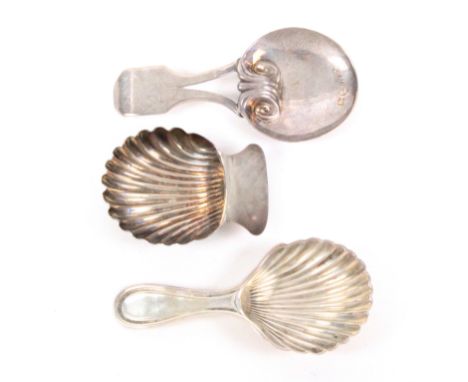 Three silver caddy spoons, comprising a shell bowl example with plain handle, unmarked, 5cms, another, unmarked, 8cms, and an
