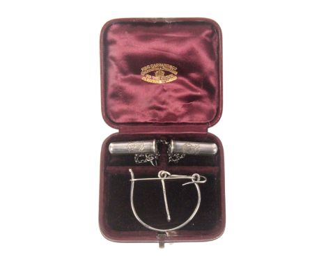 An unusual leather cased set of silver knitting needle protectors and companion wool ball retainer, the protectors of plain c