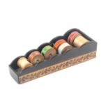 A Tunbridge ware coromandel wood reel holder of trapezoid form, the sides with a band of floral