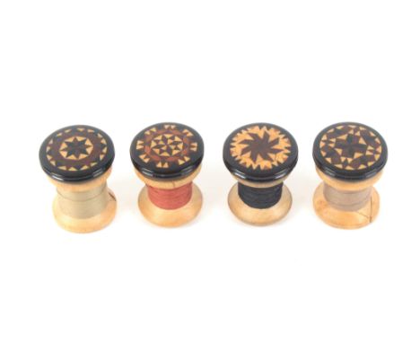 A set of four Tunbridge ware rosewood reel tops, each with circular variant stick ware top and reel spike, with a set of four