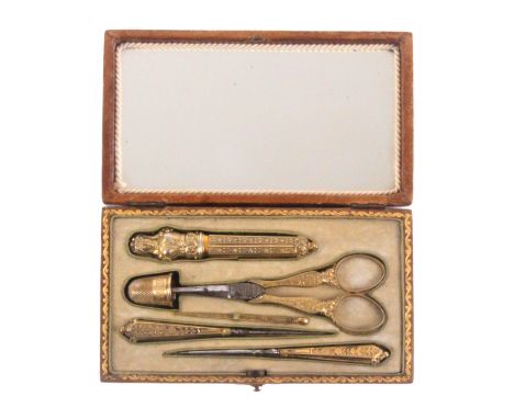 A good French six piece silver gilt sewing set in the style of Palais Royal, circa 1840, contained in a brown leather and gil