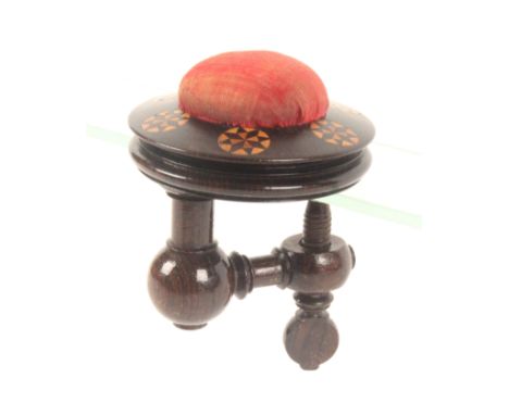 A rosewood Tunbridge ware sewing clamp, the turned frame below a circular top inlaid with six circles of stick ware and centr