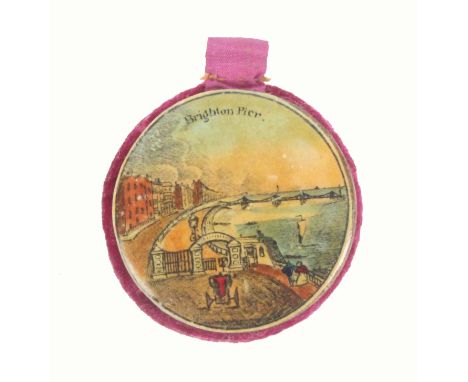A good Tunbridge ware colour print decorated disc form pin cushion, one side with a titled view 'Brighton Pier', the reverse 