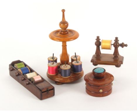 Four wooden reel boxes and stands, comprising a sycamore example, the turned base on three bun feet with six brass reel rods,