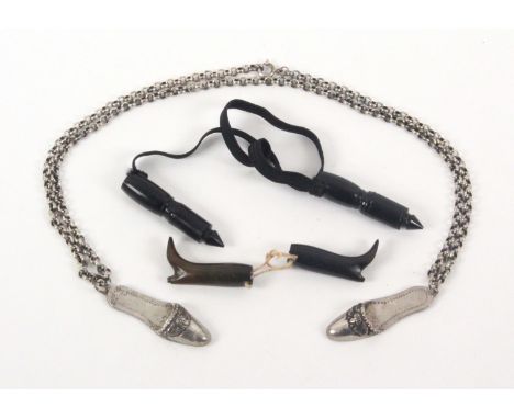 A Dutch silver knitting needle holder in the form of a pair of slippers, united by a double chain with securing ring, indisti