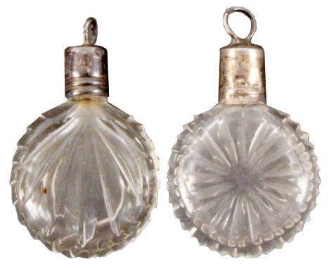 Two Georgian miniature glass scent bottles, each of circular cut form both with silver gilt screw covers below a ring and com