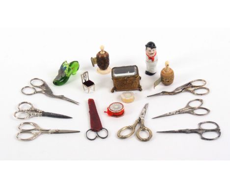 A mixed lot - sewing, comprising eight pairs of scissors including a pair with silver handles, 9cms, two vegetable ivory tape