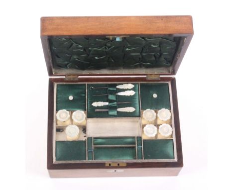 A rosewood sewing box of plain rectangular form, circa 1860, the lid and front with mother of pearl ovals, the lid interior i