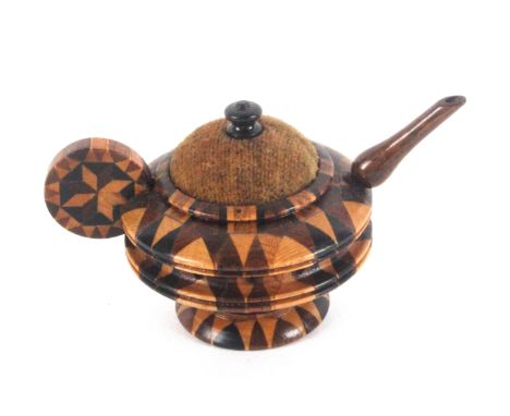 A Tunbridge stick ware pin cushion and pin wheel in the form of a tea pot, velvet pad with turned finial, 7cms wide.         