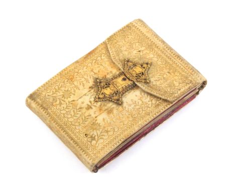 A gilt tooled vellum hussif with elaborate pierced and engraved silver gilt catch, circa 1820, the interior with two pink sil