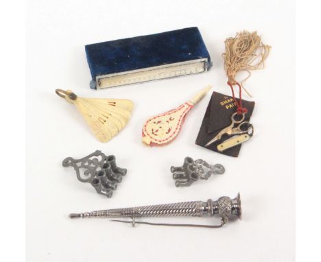 A mixed lot - sewing, comprising two elaborate soft metal needle threaders, largest 4cms, a bone fan for a doll, 6cms, a smal