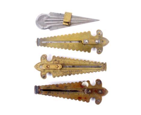 Four button hole cutters, comprising three fancy brass triangular examples with sliding blades, one stamped 'Wescter Mfg Co',